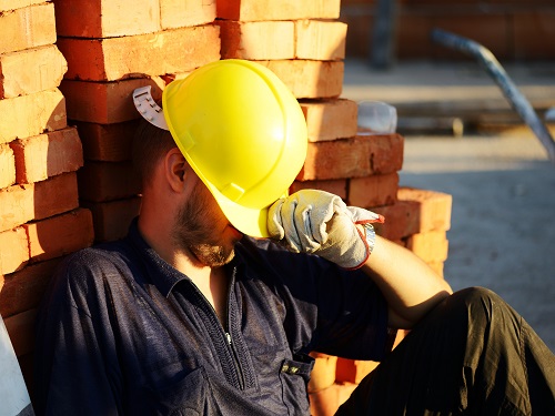 Construction worker asleep on the job.