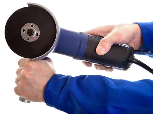 Worker Holding a Portable Grinder