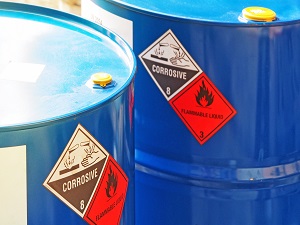 Blue 55-gallon drums with labels on them.