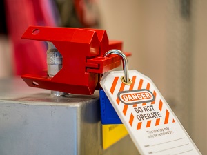 A lockout device and a tagout device on equipment.