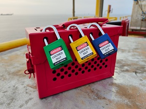 A group lockout box with three locks on it.