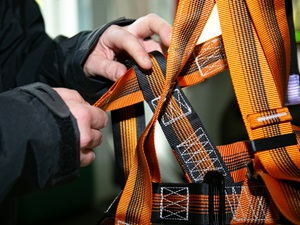 Someone is inspecting a body harness