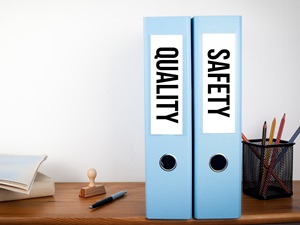 Two binders in an office, one says Quality and the other says Safety.