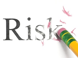 A pencil erasing the word Risk indicating that you should eliminate or reduce risk.