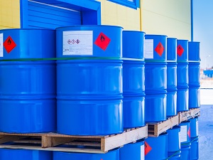 55-gallon drums with hazardous chemical labels.