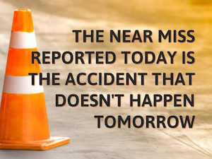 An orange traffic cone on a worksite with the safety message “The near miss reported today is the accident that doesn’t happen tomorrow” overlaid.