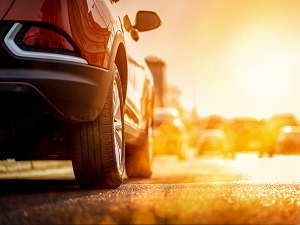 View of the side of a car parked in a parking lot on an obviously hot day.