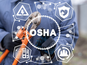 A worker in protective gloves holds a large tool, with a digital overlay showing safety icons and the word “OSHA” in the center.