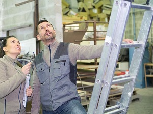 Two Workers Inspecting Extension Ladder