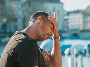 Man with Head in Hand Feeling Stress