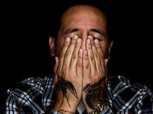 Worker is Upset, Covering Face and Eyes with Hands