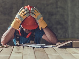 Construction Worker Tired at Work, Head in Hands