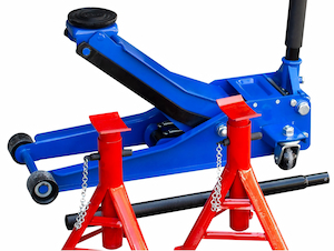 A blue hydraulic floor jack with two red jack stands positioned nearby on a white background.