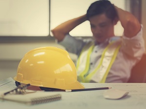 Construction Worker Feeling Tired, Sitting at Desk