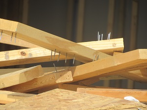 Pile of Lumber with Protruding Nails