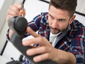 A worker putting together or fixing an office chair.