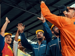 A work team having a positive safety meeting, looking cheerful.