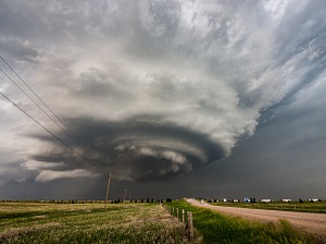 A dark, gigantic funnel cloud that looks like it could turn into a tornado.