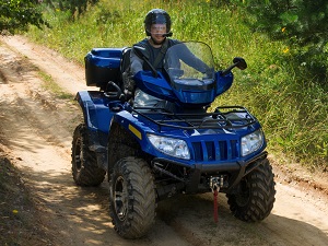 Person driving an all-terrain vehicle.