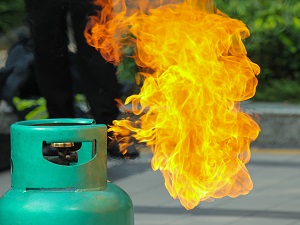 A propane tank that has caught on fire.