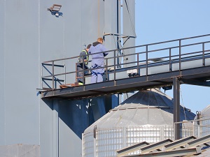 Two maintenance workers at a grain handling facility.