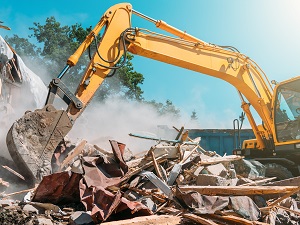Excavator working at a demolition job site.