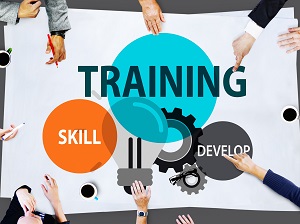 Workers pointing to a sign that says the word Training.