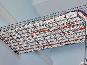 Cable tray routing cables through a wall.