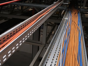 Unsecured cables running through cable trays.