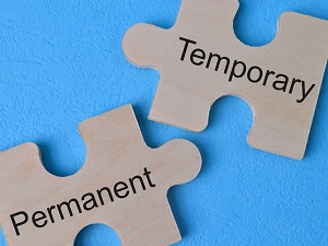 Two puzzle pieces on a blue background, one says the word Temporary and one says the word Permanent.