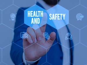 A person pointing to a graphic that says "Health and Safety"