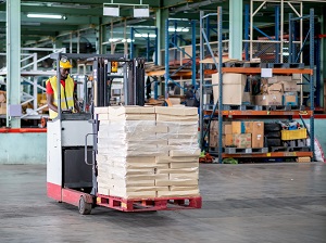 Warehouse worker operating a forklift.