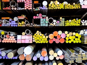 Metal rods that are color coded on the ends stacked neatly in racks to create a colorful display.