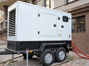 Larger portable generator on a trailer that is outside of an office building.