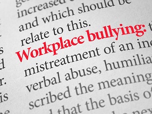 A dictionary page showing the definition of Workplace Bullying.