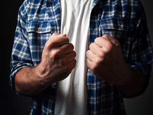 A person with their fists raised indicating they are ready to fight.