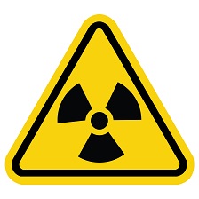 Radiation hazard sign in yellow and black that is shaped like a triangle.