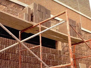 Scaffold loaded with materials but the platforms are not fully decked.