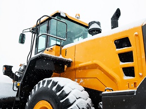 Heavy Equipment on Construction Site with Visible Snow