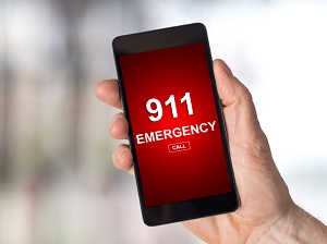 Someone holding a cell phone about to call 911.