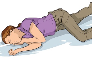 Illustration showing a person on their side in the recovery position.