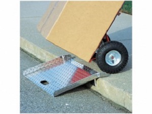 Pushing a hand truck over a curb ramp.