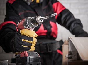 Worker Holding a Battery-Powered Drill