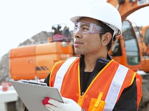 Worker Near Heavy Equipment Wearing PPE including HVSA