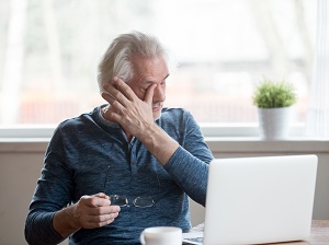 Person Rubbing Eyes After Working on Computer