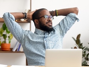 Man Taking a Break from His Computer, Leaning Back