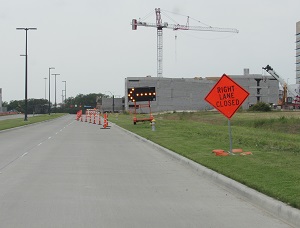 Beginning of Work Zone on Road with Right Lane Closed Sign Visible on the Right