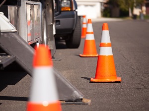 Orange Traffic Cones Warning Drivers of Parked Trucks on Roadway