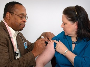Medical Doctor Providing Flu Shot to Woman