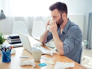 Office Working Blowing His Nose and Obviously Sick